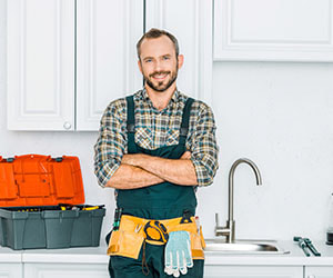 A Geelong plumber holding tools for kitchen plumbing repairs